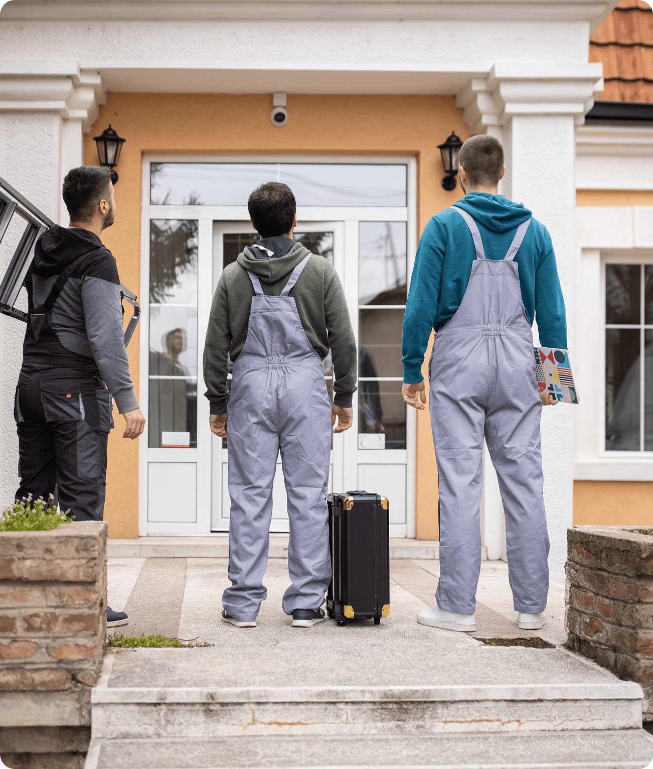 Workers standing outside a house entrance