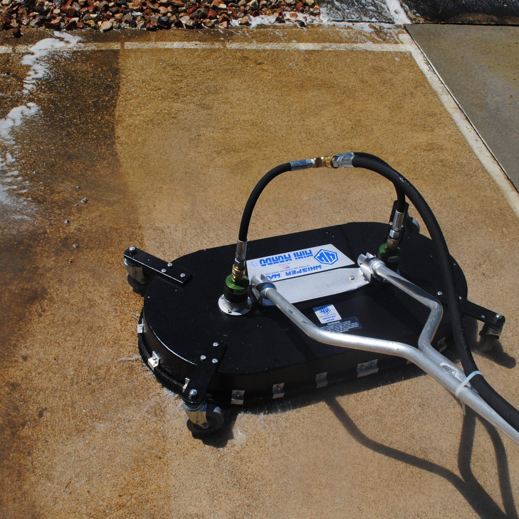 Pressure washer surface cleaner on concrete driveway